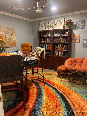 living area with ornamental molding and visible vents