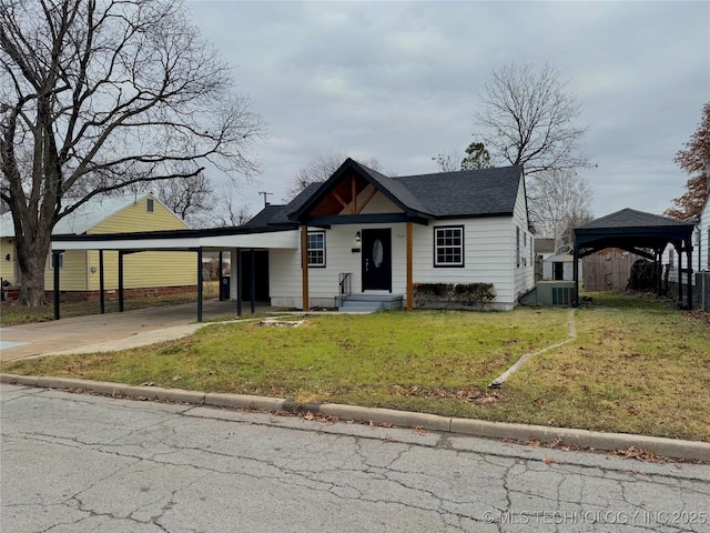 bungalow featuring driveway, a shingled roof, a front lawn, and central AC