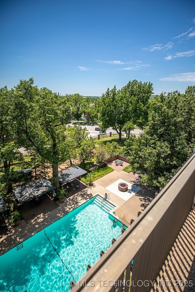 view of swimming pool featuring a fire pit