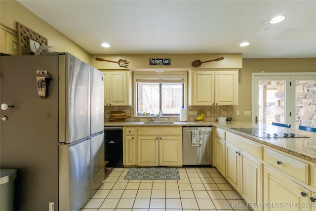 kitchen featuring tasteful backsplash, appliances with stainless steel finishes, a sink, and recessed lighting