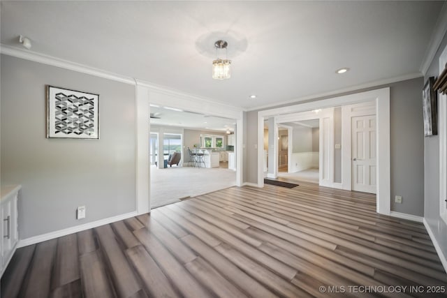 empty room featuring baseboards, ornamental molding, wood finished floors, french doors, and recessed lighting