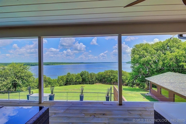 doorway to outside featuring a water view, wood finished floors, and a wealth of natural light