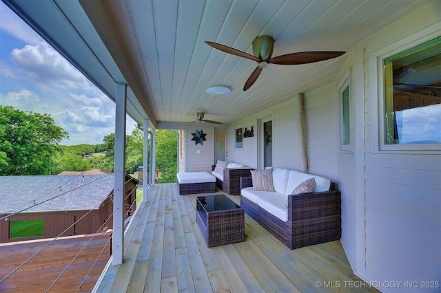 deck with a ceiling fan and an outdoor living space