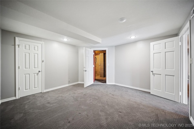 interior space with dark colored carpet, baseboards, and recessed lighting