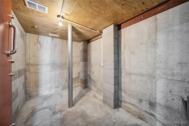 unfinished below grade area featuring wood ceiling and visible vents