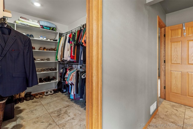 spacious closet featuring light tile patterned floors and visible vents