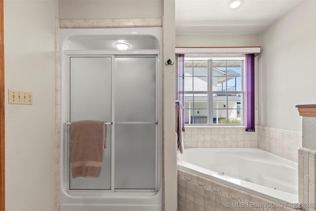 full bathroom with a stall shower and a tub with jets