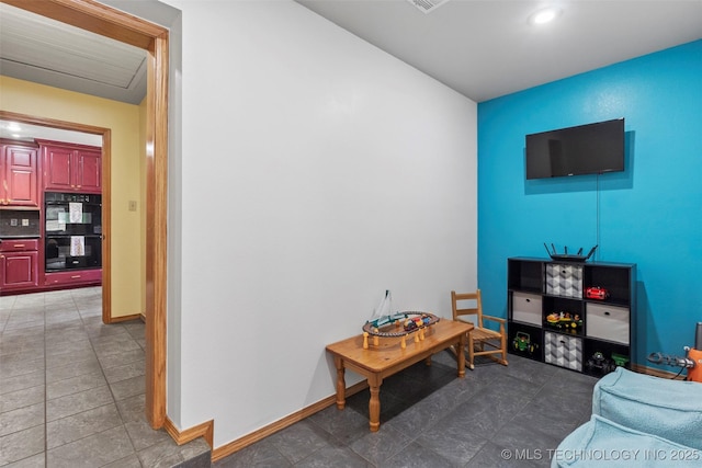 living area with dark tile patterned floors and baseboards