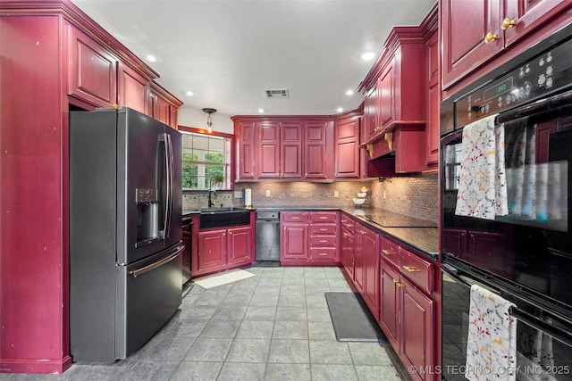 kitchen with reddish brown cabinets, dark countertops, and black appliances