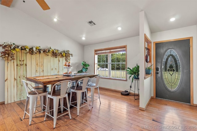 dining area with lofted ceiling, light wood-style flooring, recessed lighting, visible vents, and baseboards