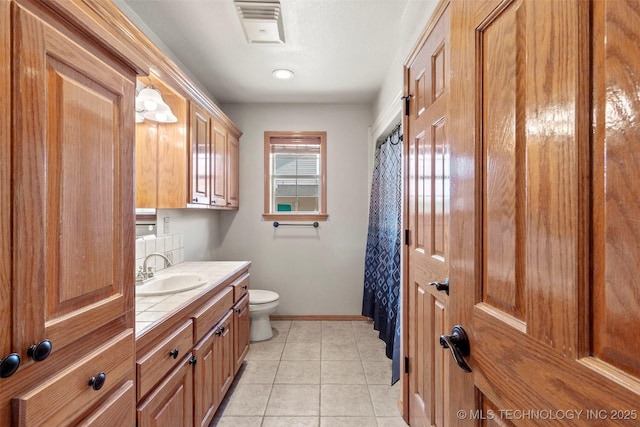 full bathroom with visible vents, baseboards, toilet, tile patterned flooring, and vanity