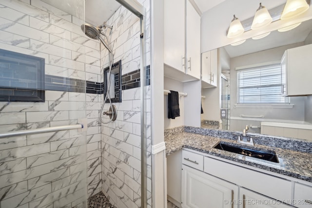 full bath with a stall shower and vanity