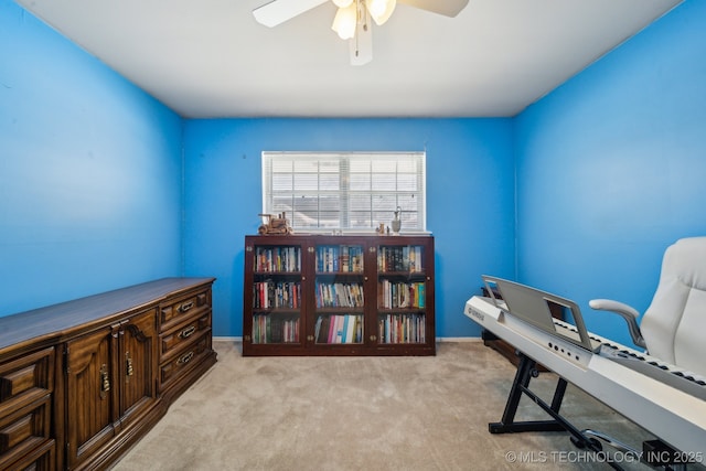 office featuring ceiling fan, baseboards, and light colored carpet