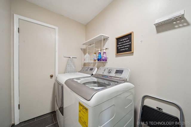 laundry area featuring laundry area, independent washer and dryer, and dark tile patterned floors