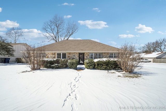 single story home featuring a garage and stone siding