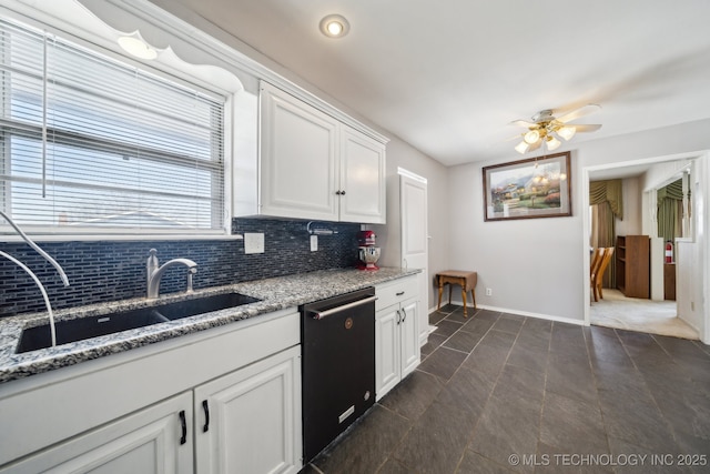 kitchen with light stone counters, white cabinets, dishwasher, and decorative backsplash