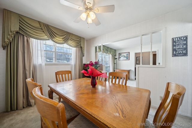 dining room featuring light carpet and ceiling fan