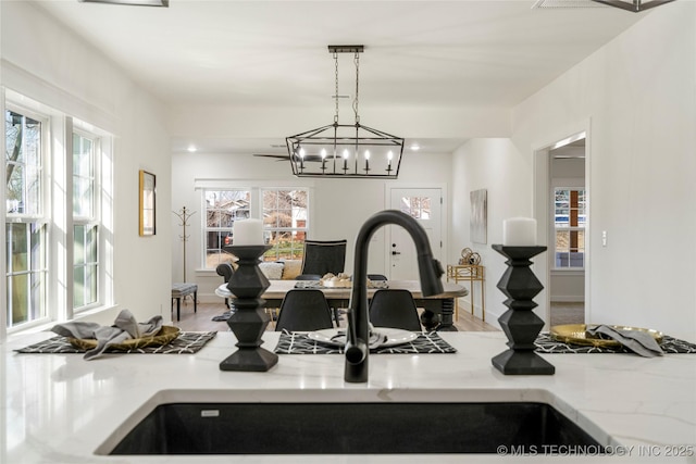 kitchen featuring pendant lighting, light countertops, and a sink