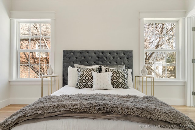 bedroom featuring baseboards and light wood-style floors