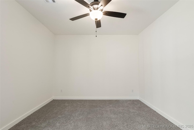 carpeted empty room featuring a ceiling fan, visible vents, and baseboards