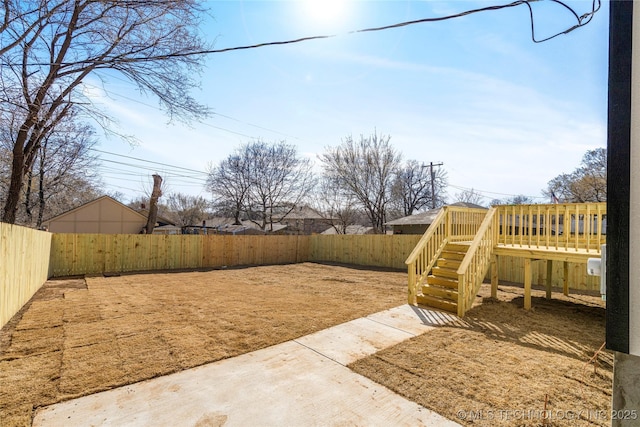 view of yard featuring a fenced backyard and a wooden deck