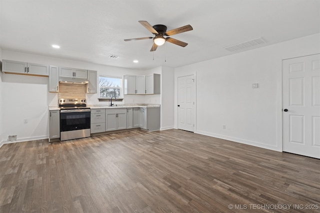 kitchen with visible vents, dark wood finished floors, gray cabinets, stainless steel range with electric cooktop, and under cabinet range hood