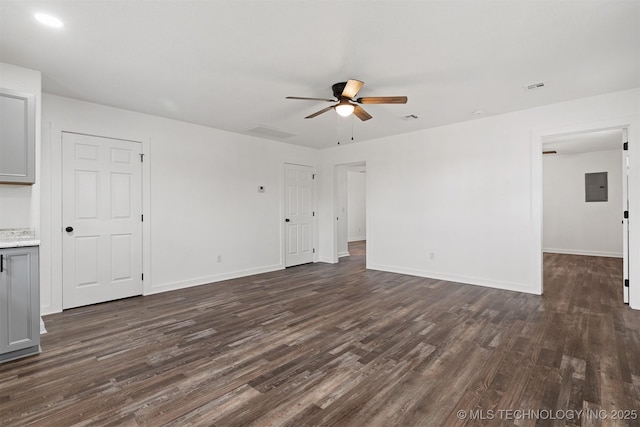 unfurnished living room featuring dark wood-style floors, electric panel, baseboards, and a ceiling fan