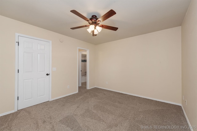 empty room featuring carpet floors, ceiling fan, and baseboards