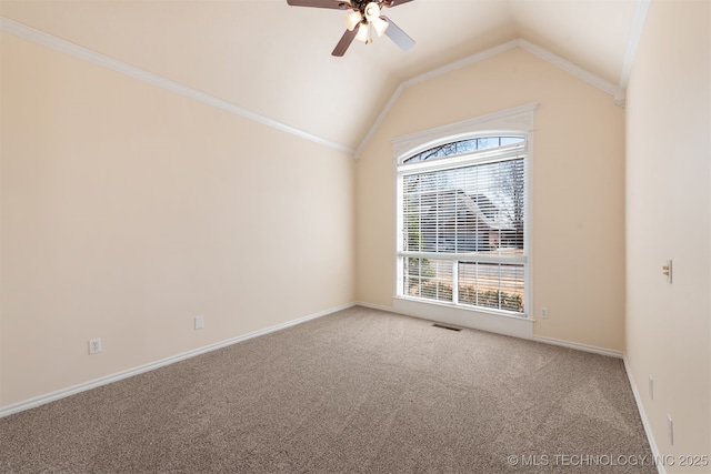 carpeted empty room with lofted ceiling, visible vents, a ceiling fan, ornamental molding, and baseboards