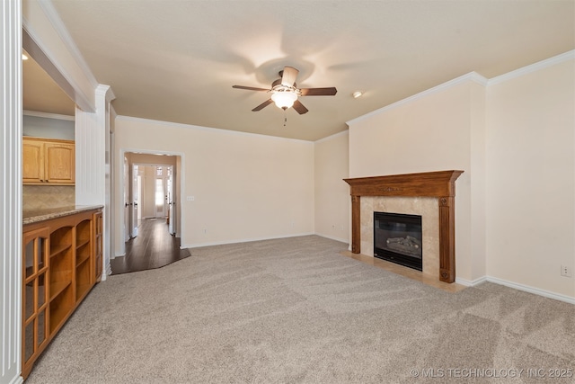 unfurnished living room featuring baseboards, a high end fireplace, and light colored carpet