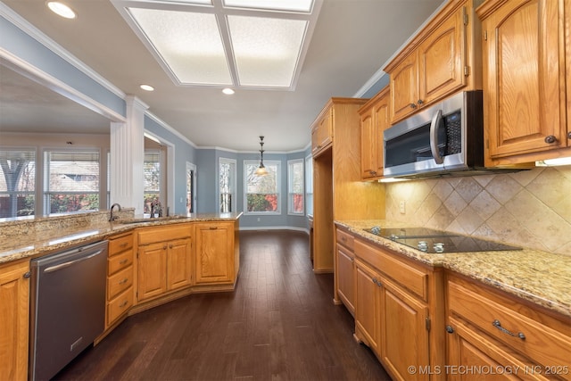 kitchen with ornamental molding, brown cabinets, decorative light fixtures, light stone countertops, and stainless steel appliances