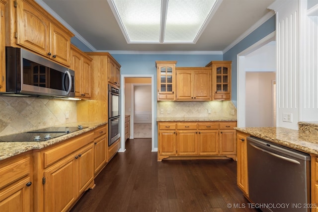 kitchen featuring light stone countertops, glass insert cabinets, stainless steel appliances, and crown molding