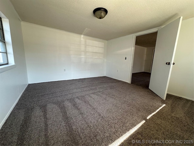 interior space with a textured ceiling and dark colored carpet