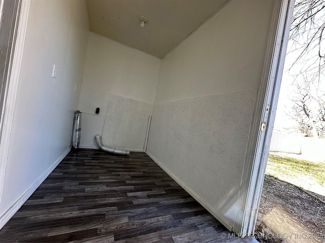 laundry room with baseboards and dark wood-style flooring