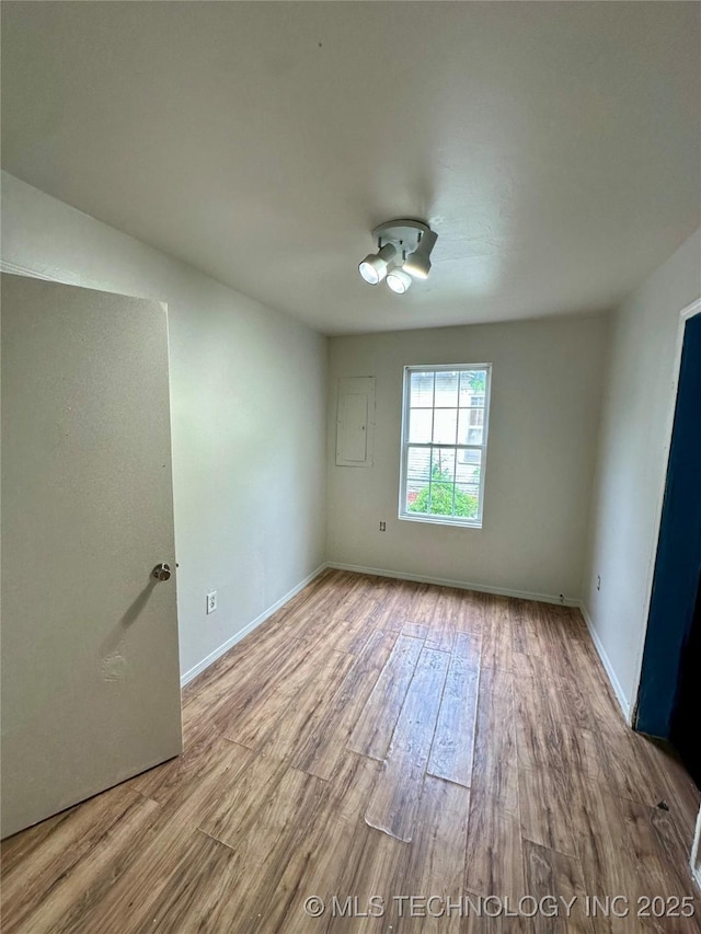 729 W 13th, Ada, OK 74820 - empty room featuring wood finished floors and baseboards