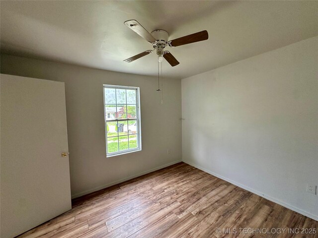 729 W 13th, Ada, OK 74820 - spare room with wood finished floors and a ceiling fan
