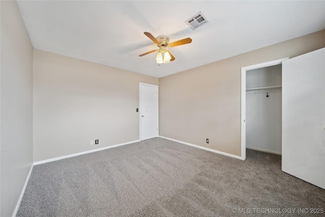 unfurnished bedroom with baseboards, visible vents, ceiling fan, carpet, and a closet