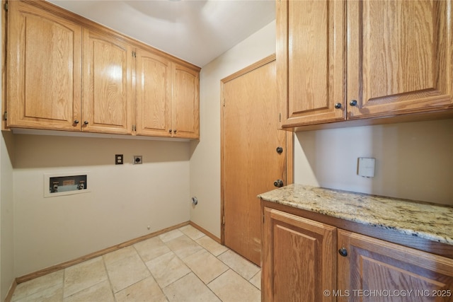 washroom featuring washer hookup, cabinet space, electric dryer hookup, and baseboards