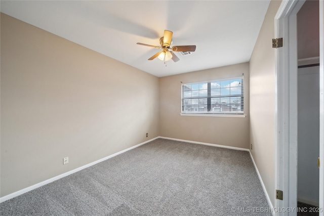 empty room with a ceiling fan, carpet flooring, visible vents, and baseboards