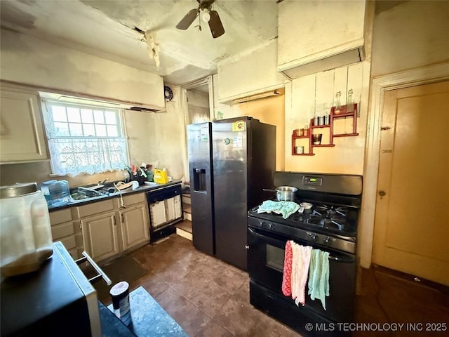 kitchen with black range with gas cooktop, stainless steel fridge, dishwasher, dark tile patterned flooring, and ceiling fan