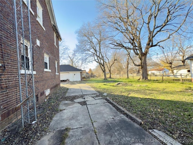 view of yard with fence and a detached garage