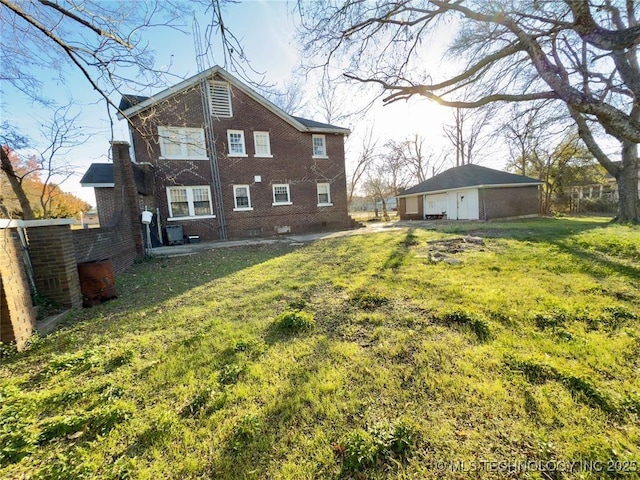 back of house featuring a lawn and brick siding