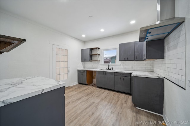 kitchen featuring open shelves, recessed lighting, decorative backsplash, a sink, and light wood-type flooring