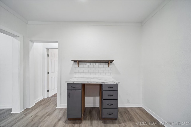 office space with crown molding, dark wood-type flooring, and baseboards