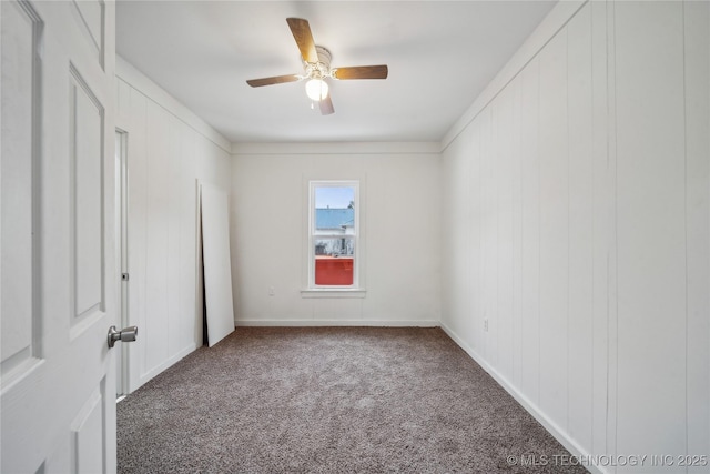 unfurnished room featuring carpet floors, baseboards, and a ceiling fan