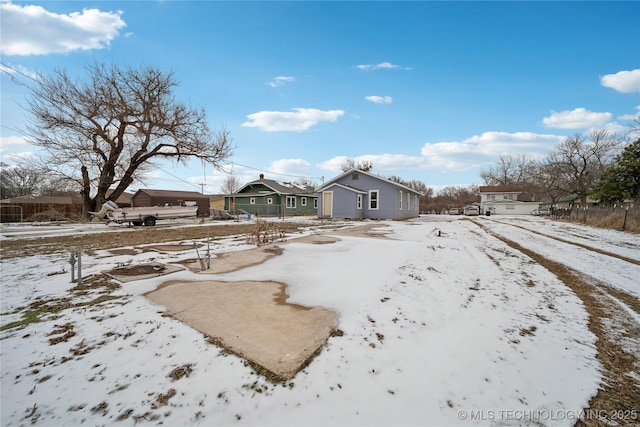 yard covered in snow with a residential view