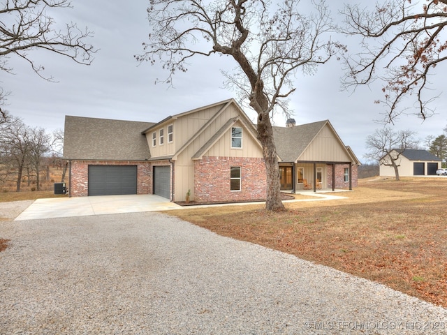 view of front of property with a shingled roof, brick siding, and driveway