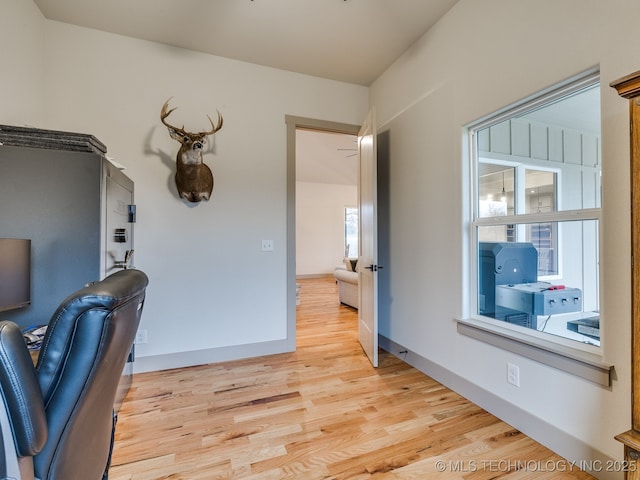 office space with light wood-style flooring and baseboards