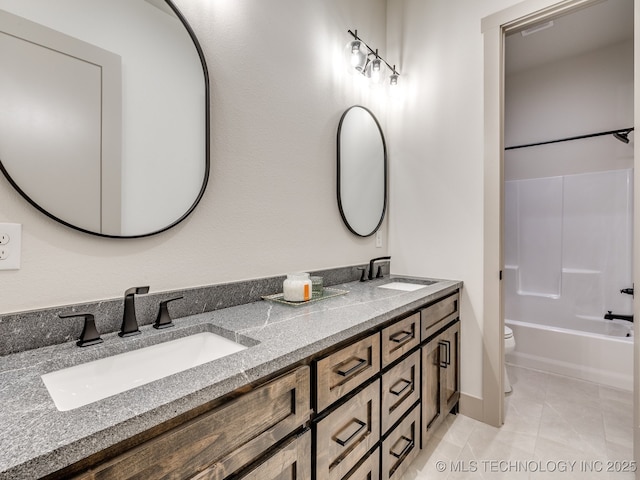 bathroom with toilet, double vanity, shower / washtub combination, and a sink