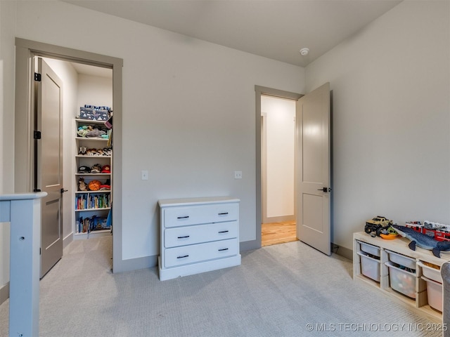 interior space with light carpet and baseboards